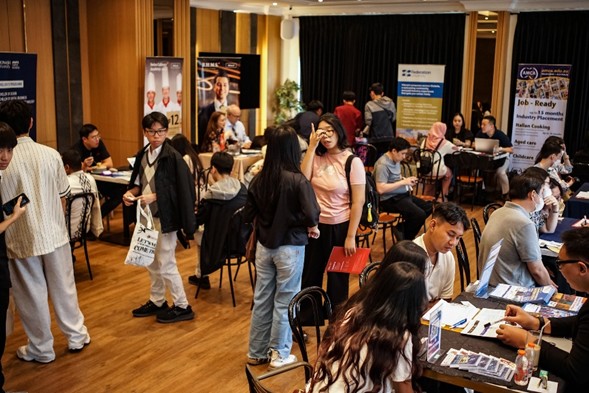 Visitors meeting university representatives at booths during the Superstar Education Fair 2026 in Jakarta
